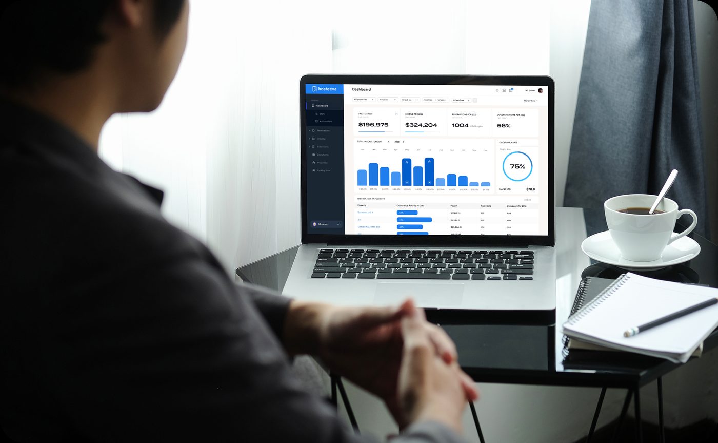 An owner reviewing their Hosteeva dashboard on a laptop